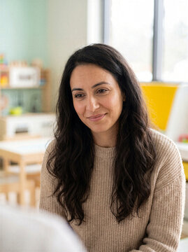 Portrait of smiling middle aged woman nodding with relief during supportive conversation in bright home interior