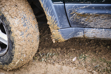 A 4x4 off-road vehicle driving through deep mud on a challenging trail, representing adventure, outdoor exploration and extreme driving conditions. © jarizPJ