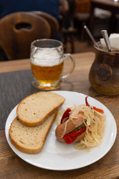 Czech utopenec with bread and beer in Cesky Krumlov
