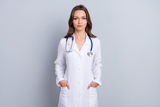 Photo of qualified lady specialist put hands pocket ready save patient life isolated over grey color background