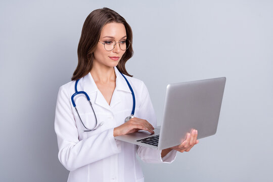 Photo of qualified therapist lady use netbook search covid symptoms cure sickness isolated grey color background