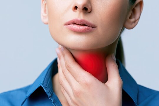 Woman touches neck to thyroid gland disease symptoms. Glowing red sign on throat. Endocrine inflammation hypothyroidism goiter node or larynx pain. Lymph node screening, hormones. Awareness campaign