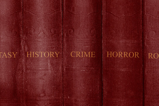 Old vintage red books with fantasy, history, crime, horror and romance genres background backdrop.