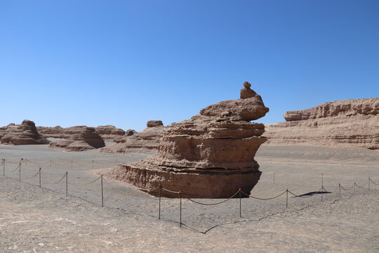 Dunhuang Yadan National Geological Park, Gansu, China. 13-09-2026. Unique yardang landform rock formation shaped like a peacock surrounded by a protective fence.
