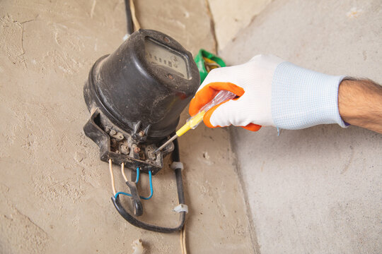 Man working an electricity meter. Counting kilowatt