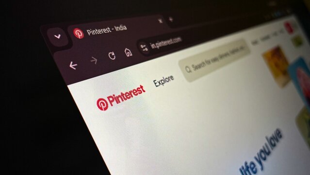 Pinterest website homepage loaded on laptop display illustrating main logo and explore search interface for visual discovery concept and creative idea browsing.