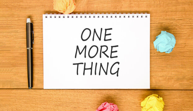 One more thing words symbol. Concept words One more thing on beautiful white note. Beautiful wooden background. Colored paper. Business and one more thing concept. Copy space.