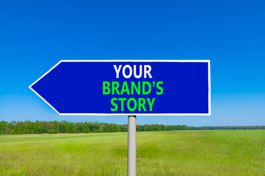 Branding and your brands story symbol. Concept words Your brands story on beautiful blue road sign. Beautiful blue sky green grass background. Business branding your brands story concept. Copy space