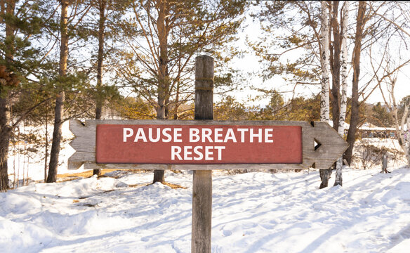 Pause breathe reset words symbol. Concept words Pause breathe reset on beautiful road sign. Beautiful winter forest background. Business support motivational pause breathe reset concept. Copy space.