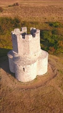 Aerial jaw shot of medieval church at sunset 