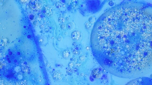 Blue liquid bubbles floating in macro abstract oil and water art