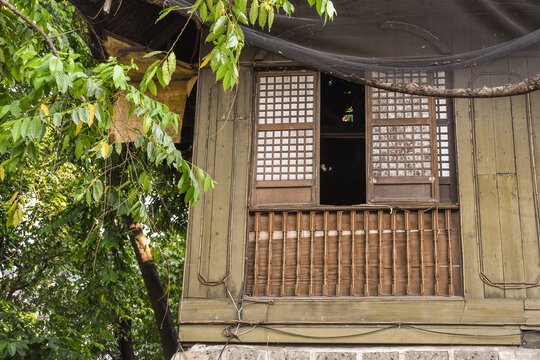 Traditional house window in the Philippines made of wood and Capiz shells. Spanish era windows. Old house with open windows.