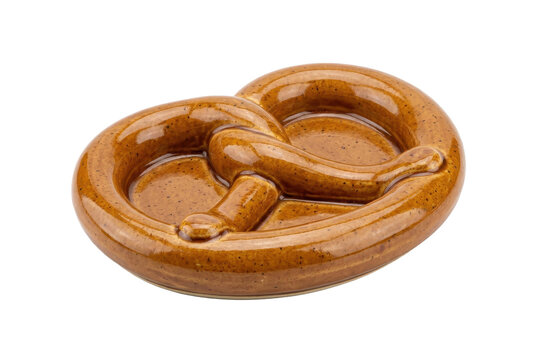 Glossy brown ceramic pretzel shaped dish isolated on black background
