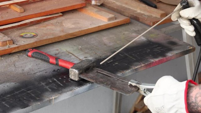Close up view of locksmith tools and welding equipment on steel workbench