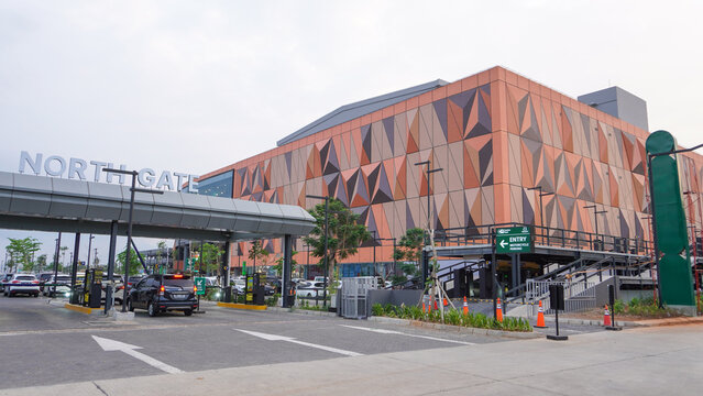 Exterior view of 23 Semarang Shopping Center with modern geometric facade, North Gate entrance, vehicle access, and contemporary architectural design in Central Java, Indonesia, captured during day.