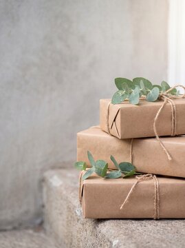 Kraft paper parcels with jute twine and eucalyptus on step