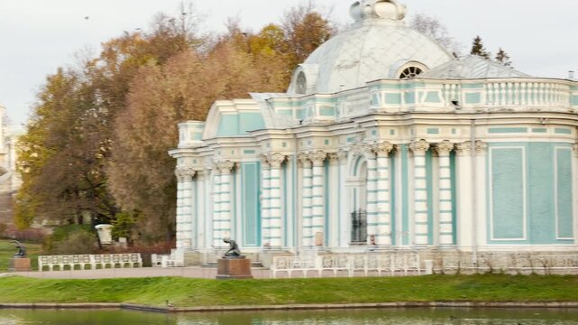 The Grotto Pavilion reflects in slow motion across the calm pond. This tranquil landmark in Catherine Park, Pushkin, Russia, evokes serene and majestic emotions.