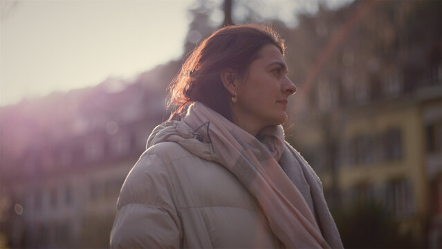 Contemplative Caucasian woman turning her head in the setting sun, mindfulness and emotional reflection