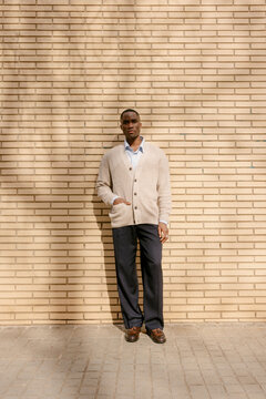 Man Standing Against Brick Wall