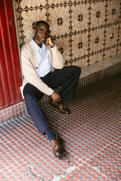 Seated Portrait by Tiled Wall