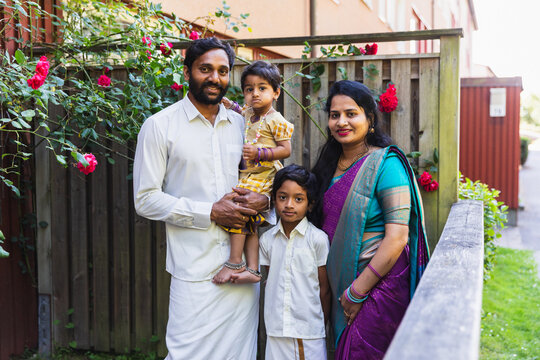 Indian Family in Traditional Clothing Standing in Garden