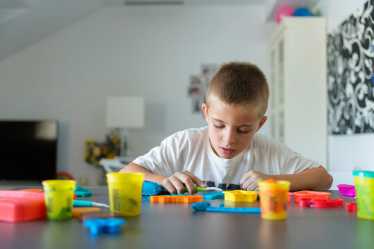 Child Molding Clay At Home Table