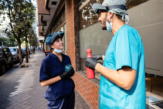 Healthcare professionals having conversation outdoors on break