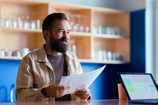 Businessman Reviewing Papers at Office