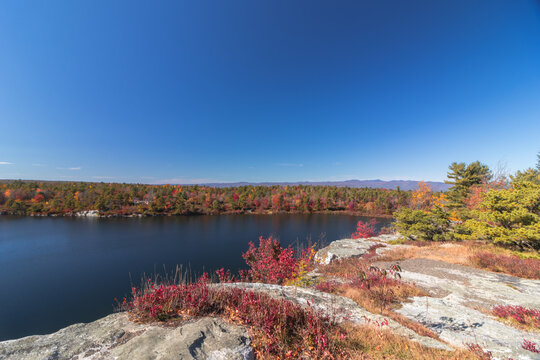 Lake Awosting in Minnewaska State Park, NY, on a crisp and clear Autumn morning surrounded by vivid fall foliage