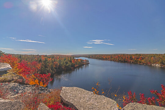 Lake Awosting in Minnewaska State Park, NY, on a crisp and clear Autumn morning surrounded by vivid fall foliage