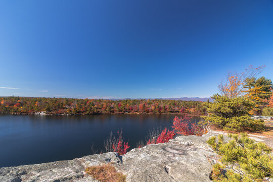 Lake Awosting in Minnewaska State Park, NY, on a crisp and clear Autumn morning surrounded by vivid fall foliage