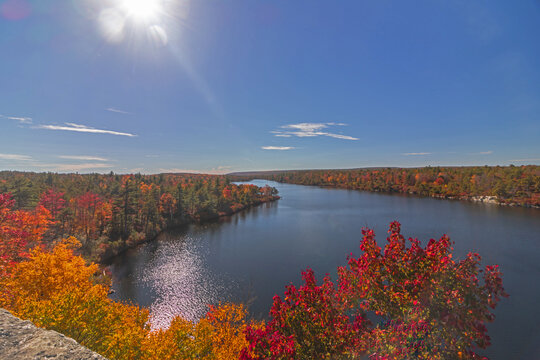 Lake Awosting in Minnewaska State Park, NY, on a crisp and clear Autumn morning surrounded by vivid fall foliage