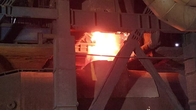 Molten metal pouring into torpedo car from blast furnace in a steel plant