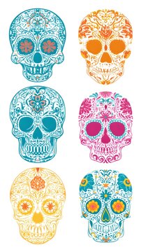 Six ornate sugar skulls with floral patterns on white background