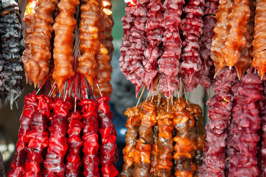 Traditional Georgian churchkhela candy hanging display. Homemade sweet nut dessert texture