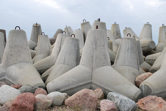 Close view of concrete tetrapods and boulders at a sea breakwater
