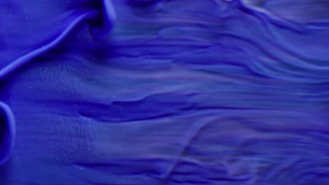 Vertical video. Paint background. Liquid splash. Defocused blue colorful water acrylic particles swirling texture art abstraction.