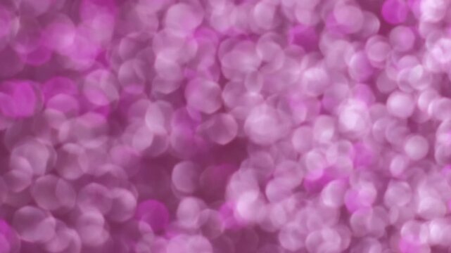 Sparkling dots. Blurred gleam. Shiny sequins glamour texture. Light leak pink purple color ray abstract bokeh illumination background.