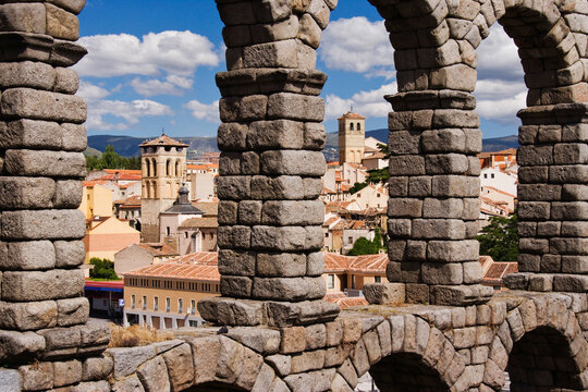 Roman aqueduct arches framing segovia cityscape