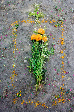 Floral arrangement on grave site with cross decoration mexico