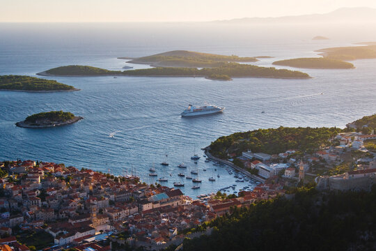 Hvar harbor with boats and cruise ship among islands