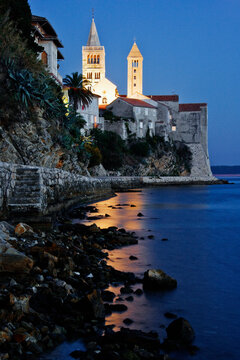 Seaside town with historic church towers on rab island, croatia