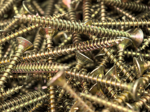 Golden screws entwined in a dense metallic maze