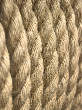 Golden hemp fibers twist into a textured rope