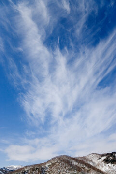 Cirrus clouds over snowy mountains, japan