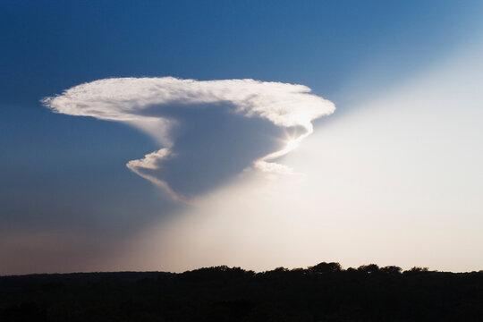 Sunlight appearing from behind cloud over Texas landscape