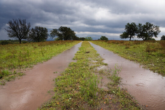 Flooded country road with stormy sky in rural Texas, USA