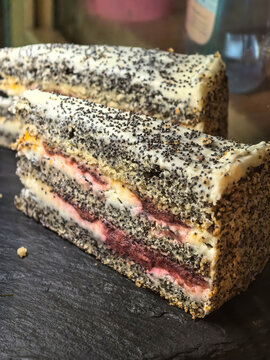 Layered berry cake dusted with dark poppy seeds