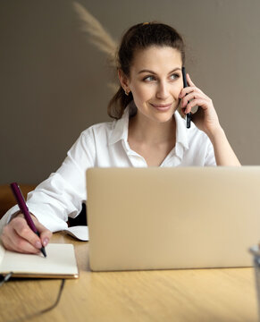 Engaging in a focused conversation while working at a modern desk with a laptop