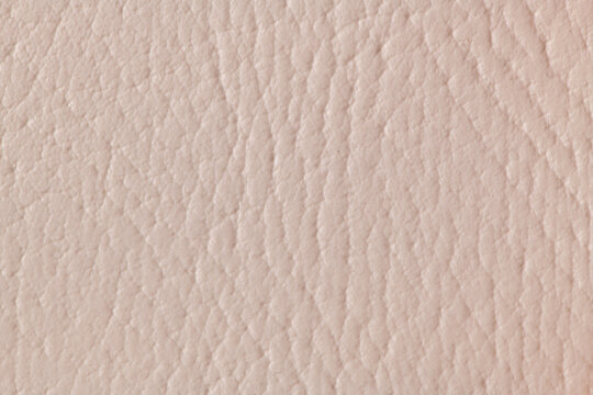 Close up of pink leather texture with natural pebbled grain pattern